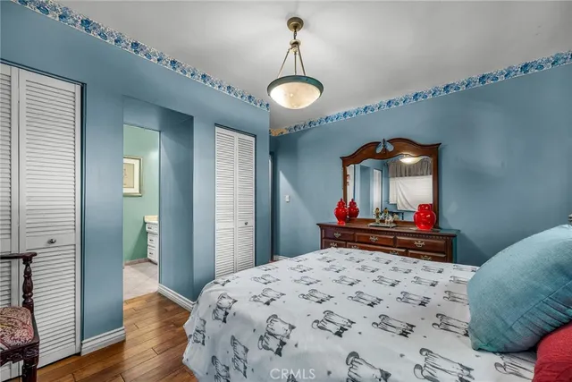 a bedroom with bed and wooden floor