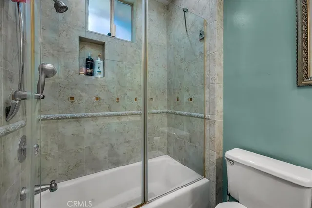 a bathroom with a shower and a toilet