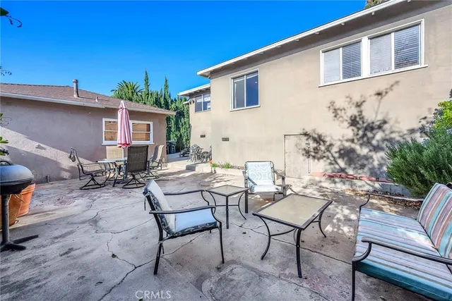 a view of a backyard with furniture and a patio