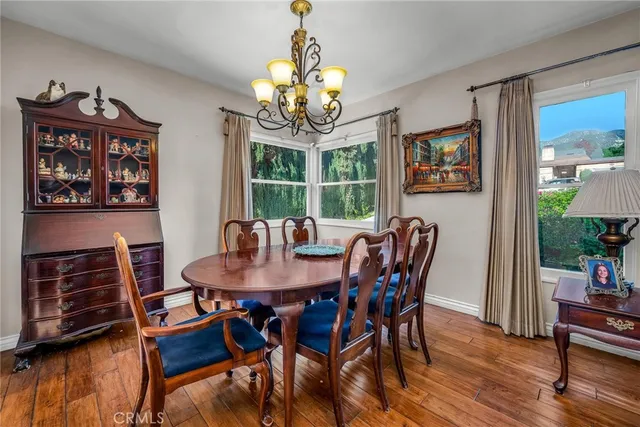 a view of a dining room with furniture wooden floor and a chandelier