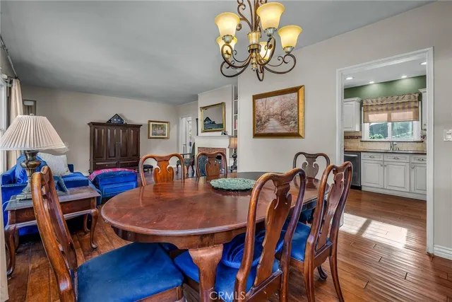 a view of a dining room with furniture wooden floor and chandelier
