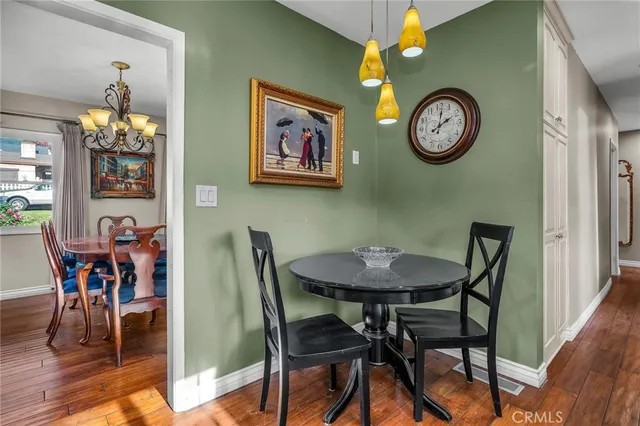 a view of a dining room with furniture and kitchen view