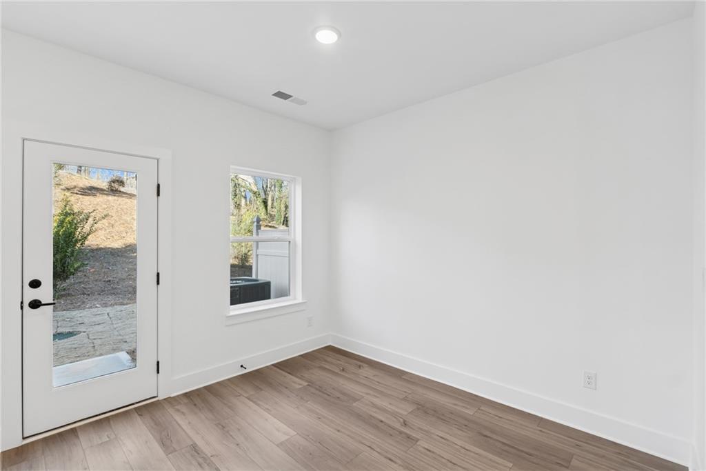 191 Redbud Road Canton, GA 30114 - Photo 7 of 15 an empty room with wooden floor and windows
