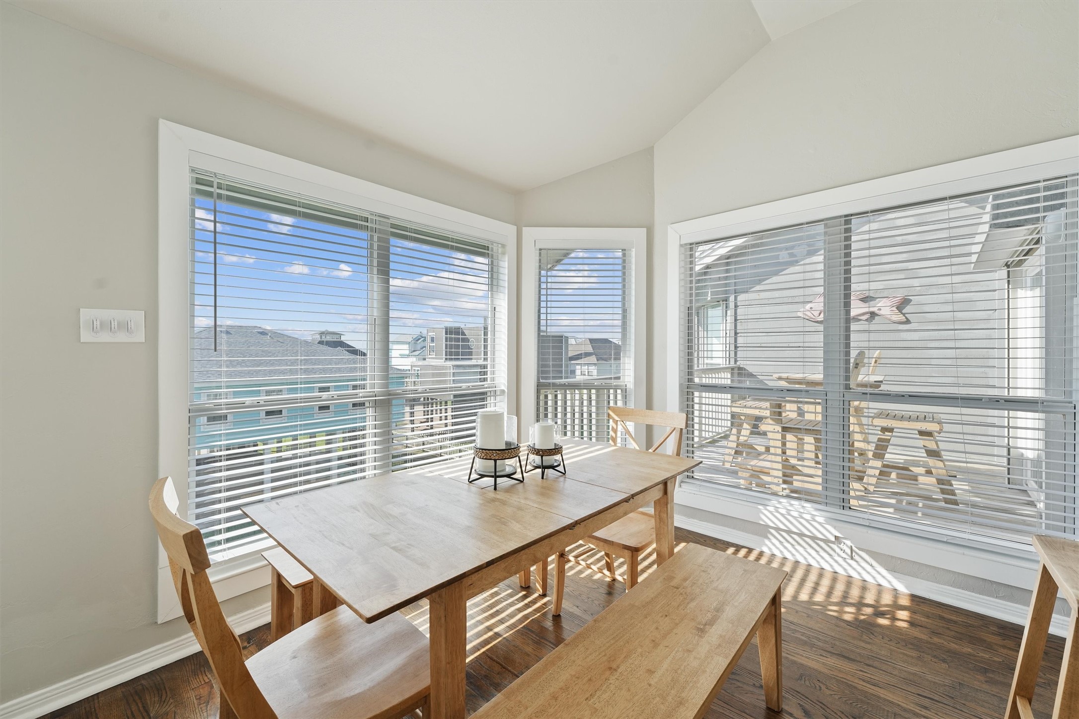 17607 Termini-San Luis Pass Road Galveston, TX 77554 - Photo 17 of 42 The dining space features a light wood table and bench, perfectly paired with the surrounding windows that bring in views of the balcony and beyond. This bright and airy nook is ideal for relaxed dining with a beachside ambiance.
