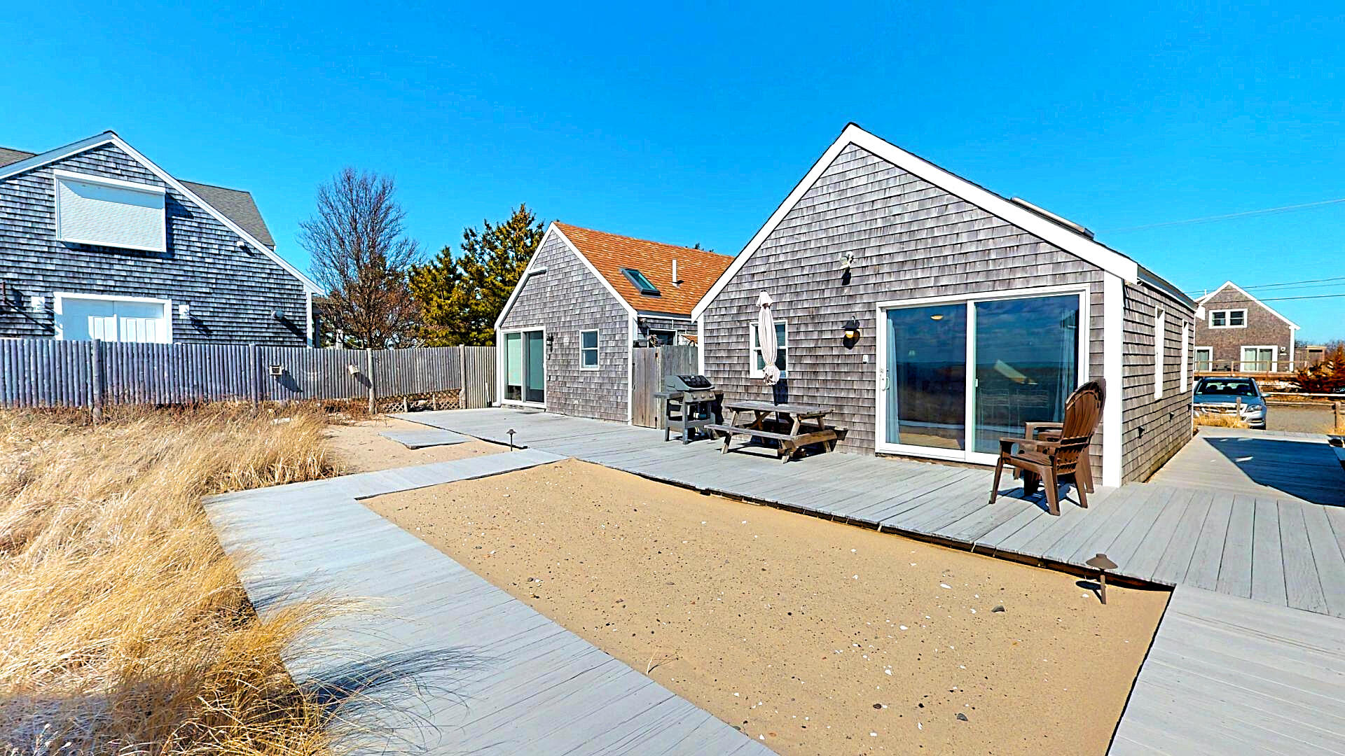 596 Shore Road, Unit G Truro, MA 02666 - Photo 2 of 27 a view of swimming pool with outdoor seating and house in the background