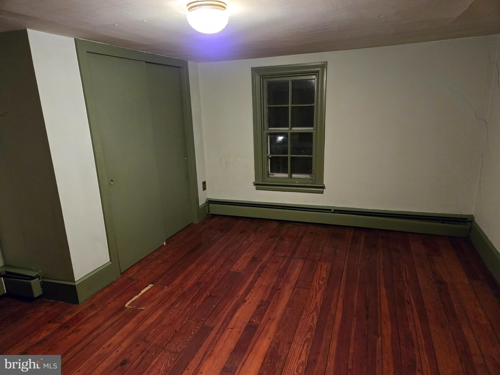6 Township Line Road Line Lexington, PA 18932 - Photo 19 of 43 a view of an empty room with wooden floor and a window