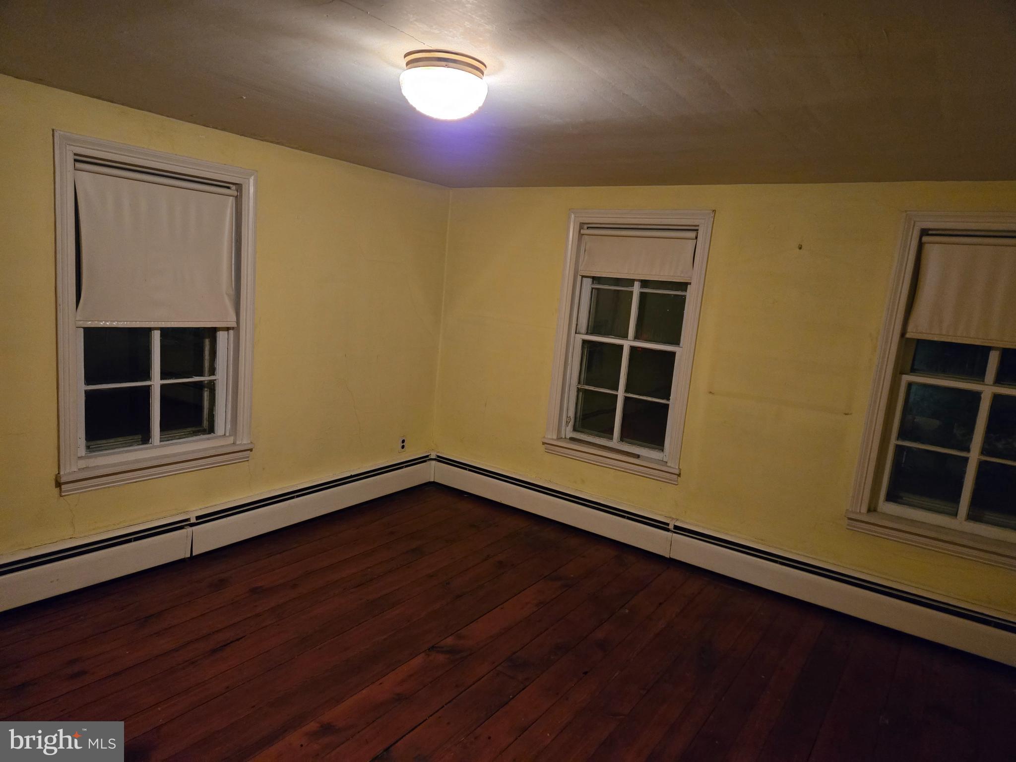 6 Township Line Road Line Lexington, PA 18932 - Photo 24 of 43 an empty room with wooden floor and windows