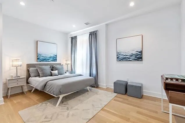 a bedroom with a bed and a couch