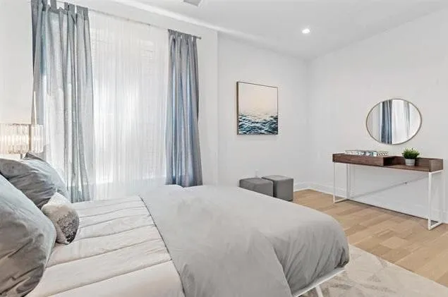 a bedroom with a large bed and a chandelier