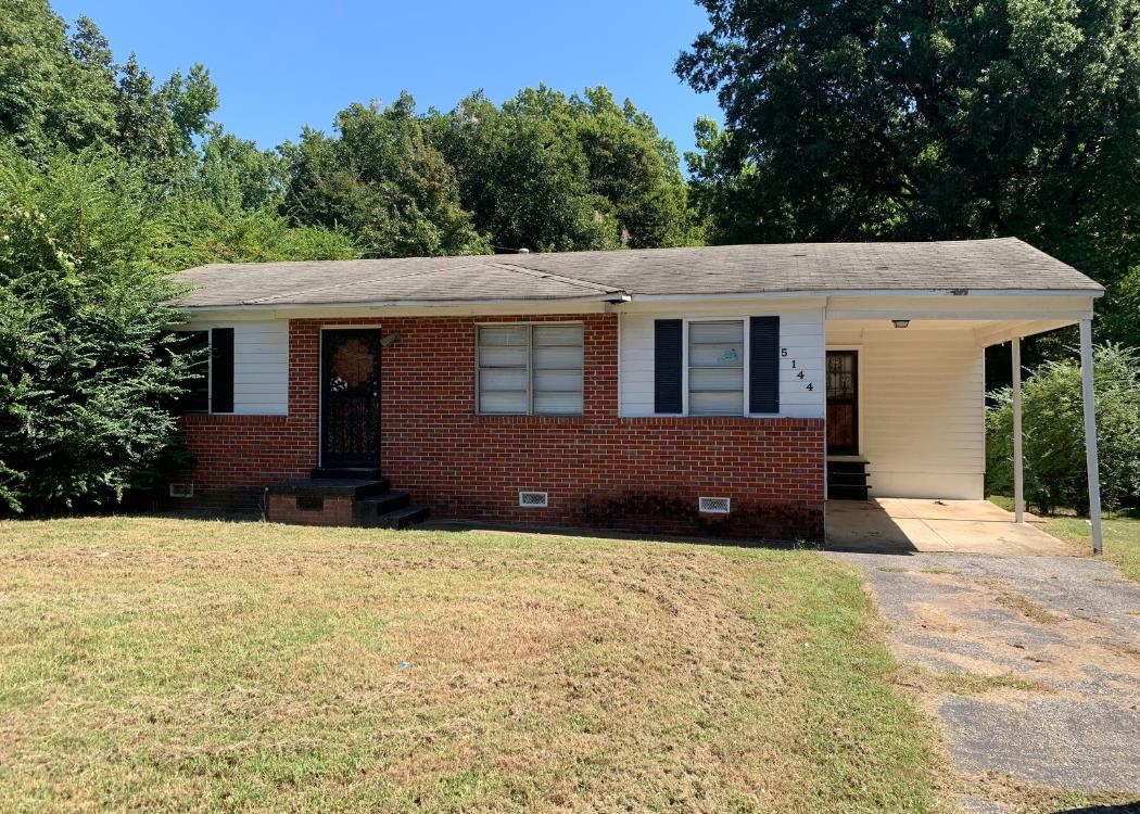 5144 Stacey Road Memphis, TN 38109 - Photo 1 of 1 a front view of a house with a yard