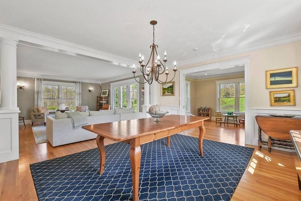 29 River Road Topsfield, MA 01983 - Photo 17 of 31 a living room with couches a table and chairs with wooden floor
