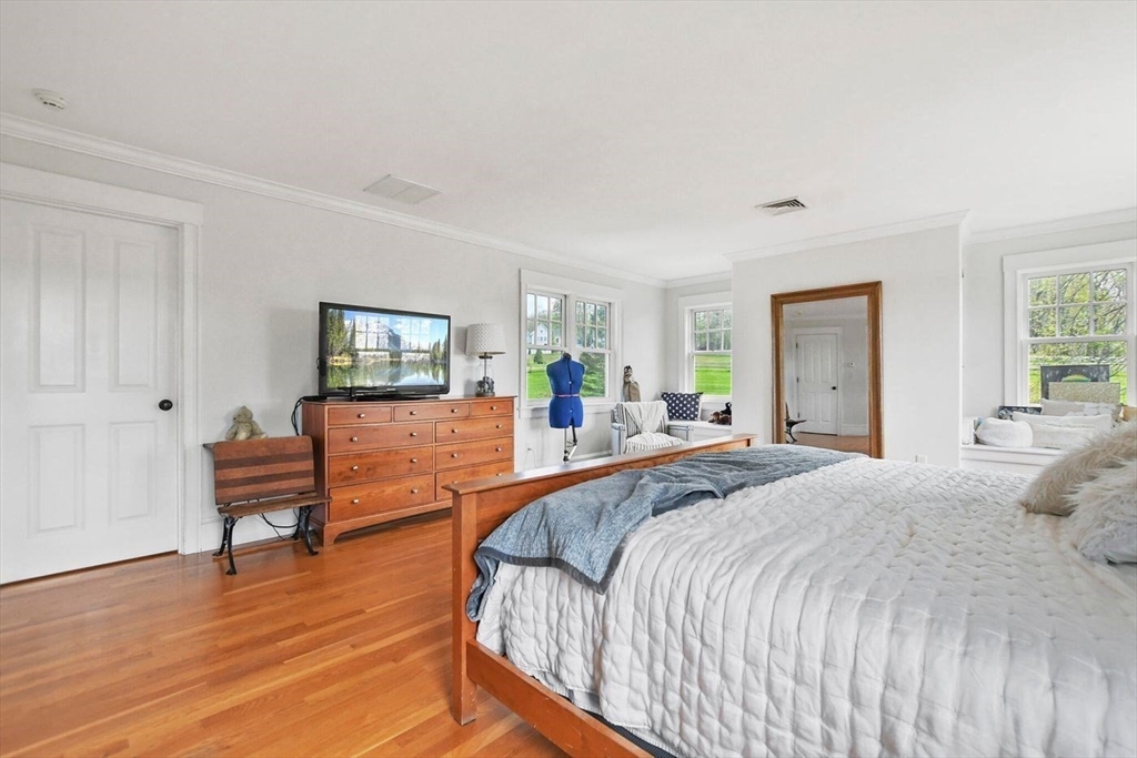 29 River Road Topsfield, MA 01983 - Photo 19 of 31 a spacious bedroom with a bed and wooden floor