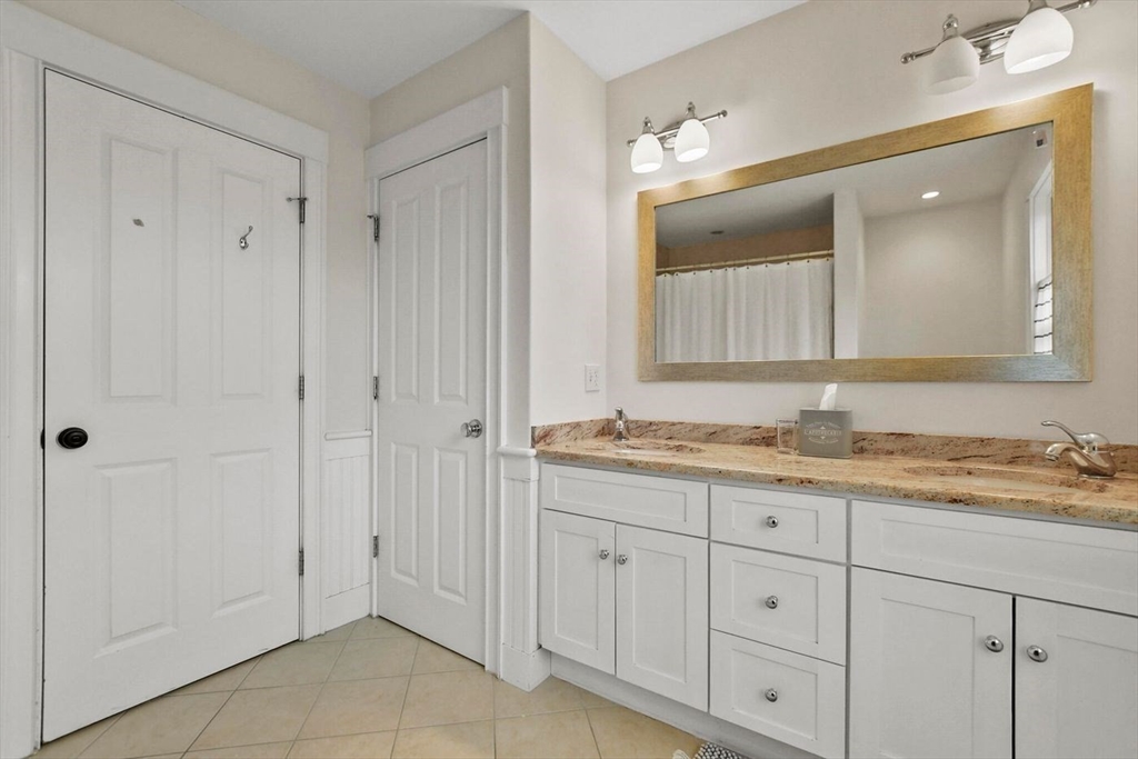 29 River Road Topsfield, MA 01983 - Photo 27 of 31 a bathroom with a granite countertop sink two mirror and a