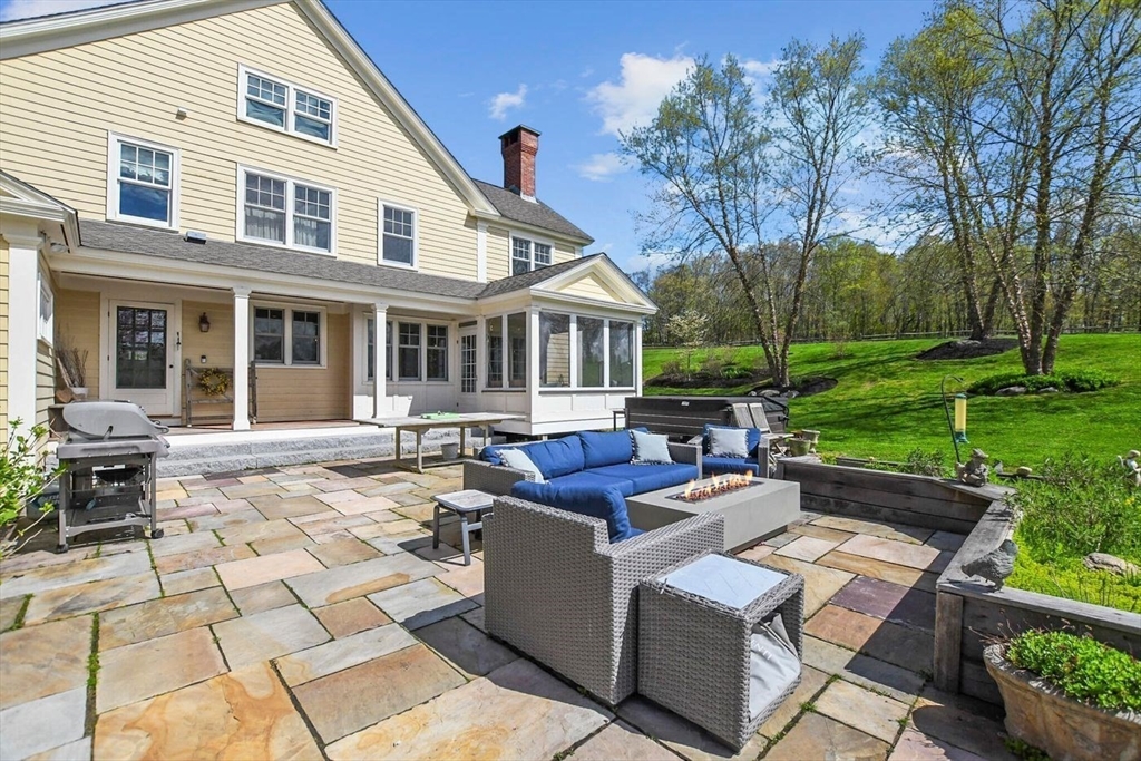 29 River Road Topsfield, MA 01983 - Photo 29 of 31 a view of a house with backyard sitting area and garden
