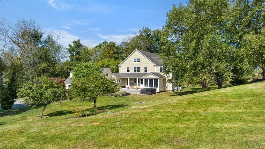 29 River Road Topsfield, MA 01983 - Photo 3 of 31 a front view of a house with a garden