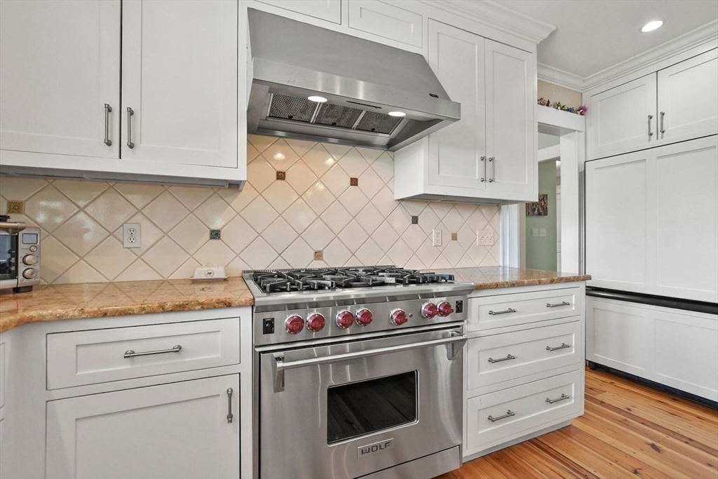 29 River Road Topsfield, MA 01983 - Photo 10 of 31 a kitchen with granite countertop white cabinets and white stove