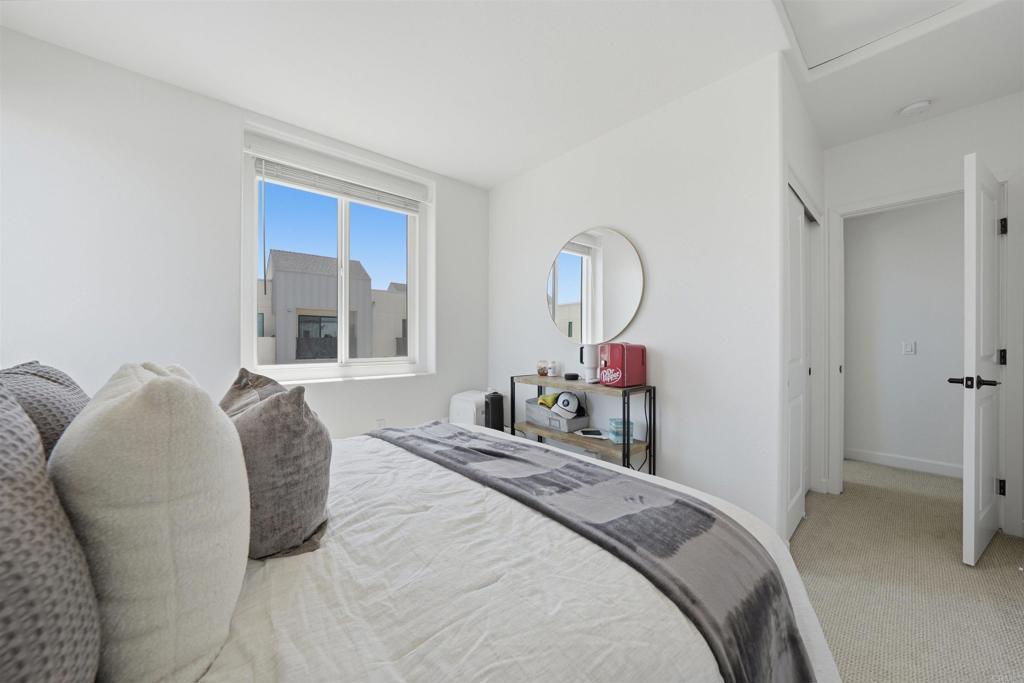 2402 Cascalote Loop San Diego, CA 92154 - Photo 25 of 35 a bed room with a bed and a mirror