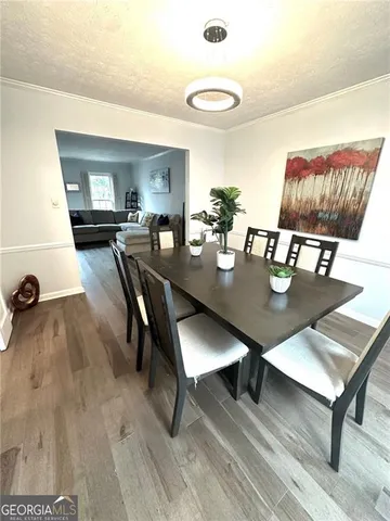 a dining room with furniture and wooden floor
