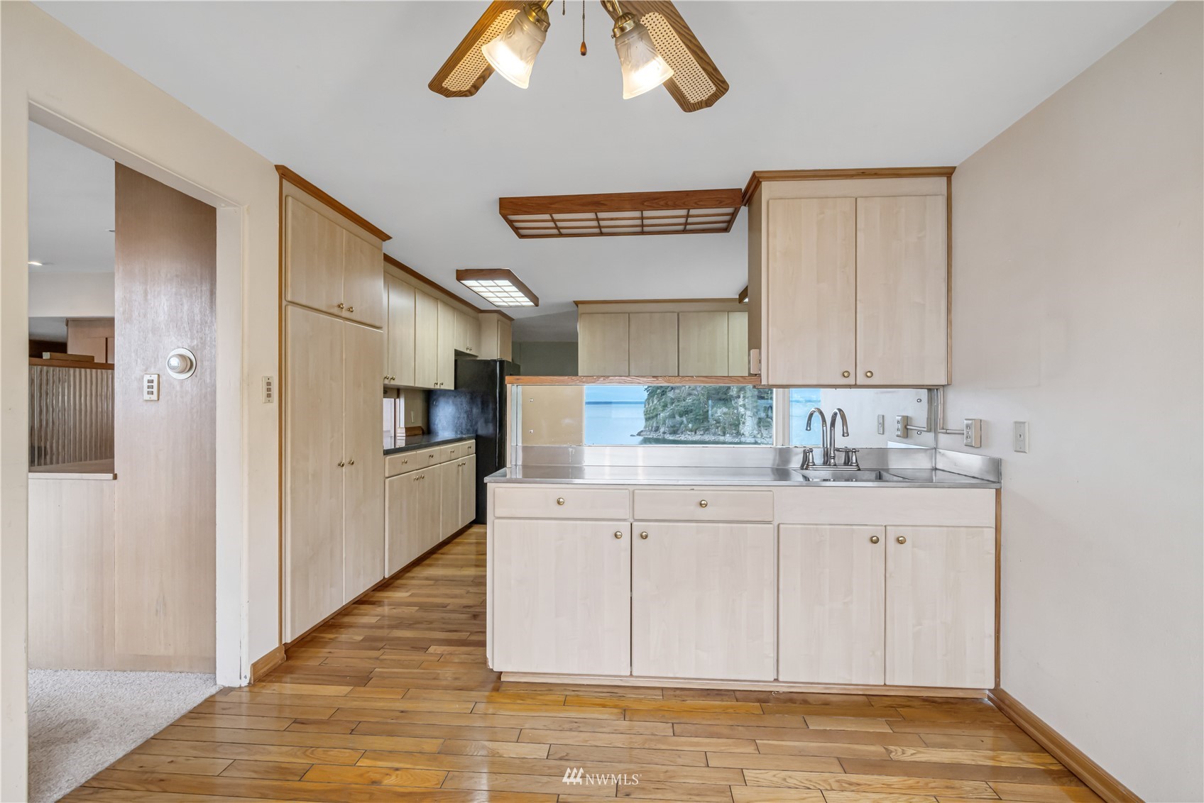 591 Pleasant Bay Road Bellingham, WA 98229 - Photo 15 of 40 a kitchen with granite countertop white cabinets and white appliances