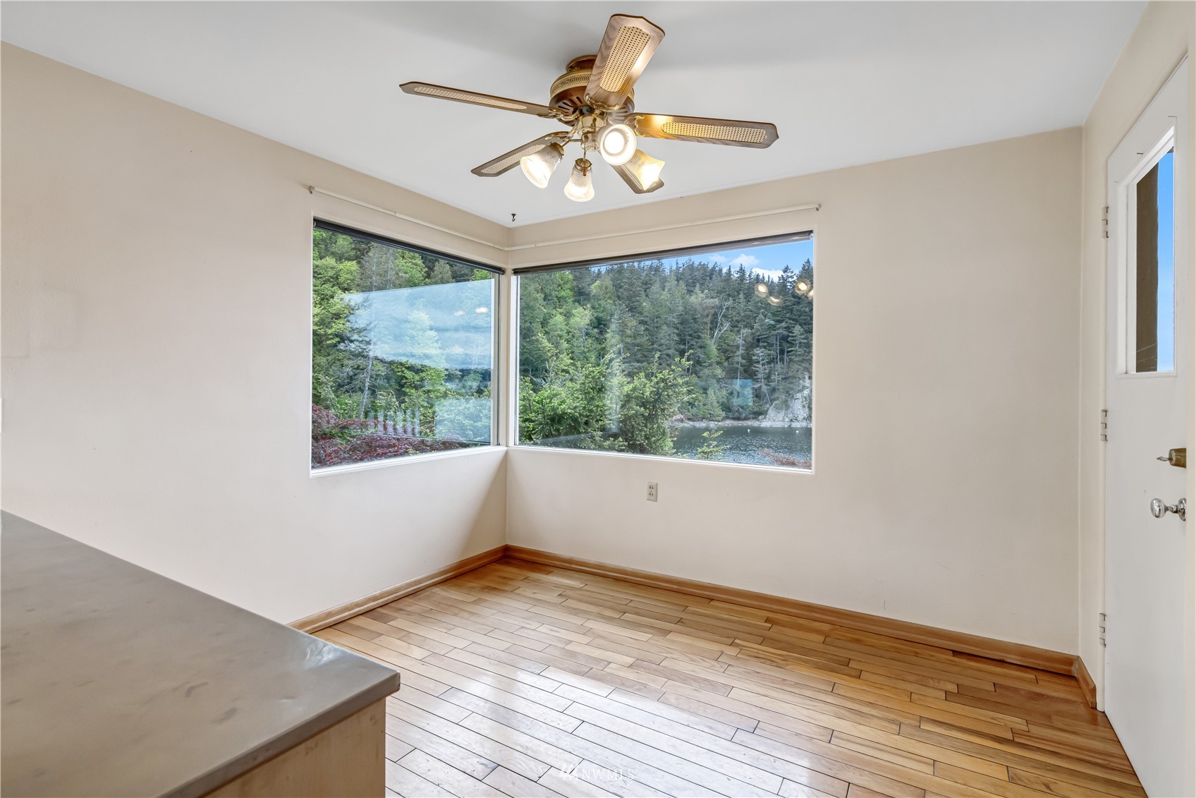 591 Pleasant Bay Road Bellingham, WA 98229 - Photo 18 of 40 a view of an empty room with wooden floor and a window