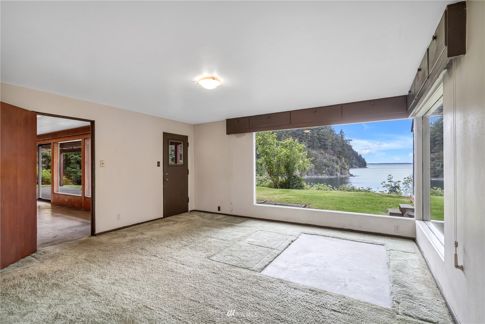 591 Pleasant Bay Road Bellingham, WA 98229 - Photo 31 of 40 an empty room with large windows and a yard