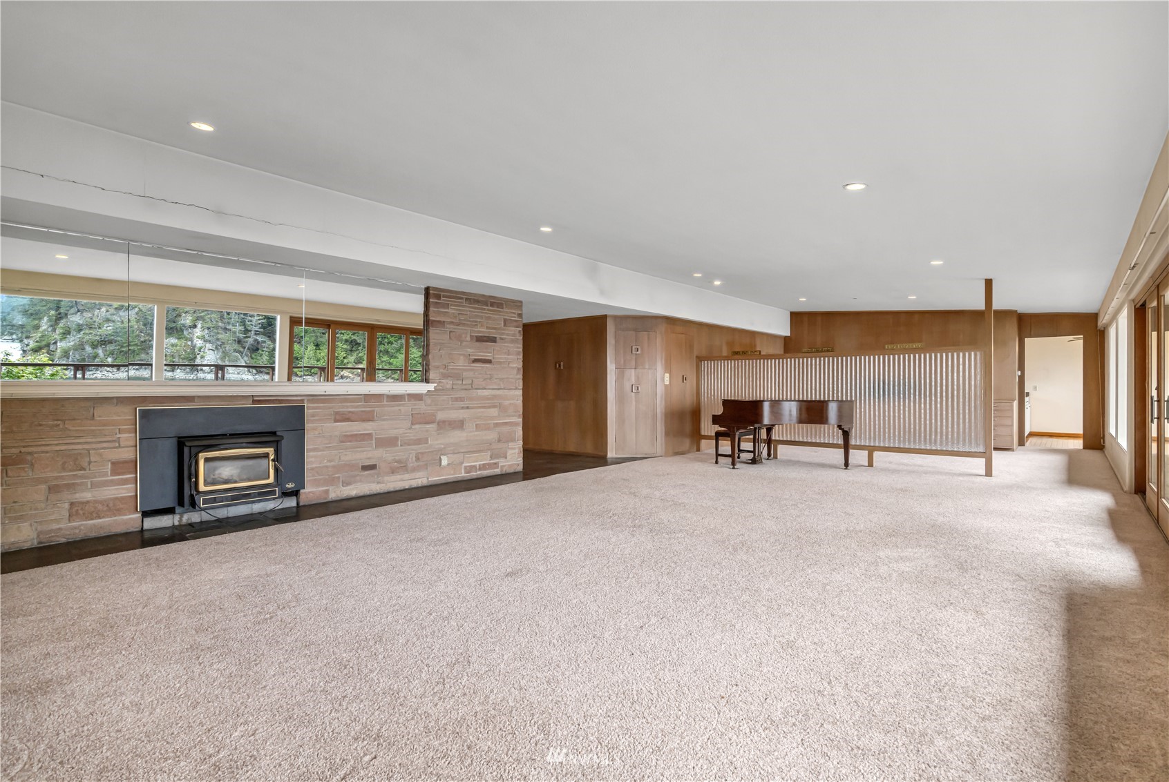 591 Pleasant Bay Road Bellingham, WA 98229 - Photo 9 of 40 a view of an empty room with a fireplace and a window