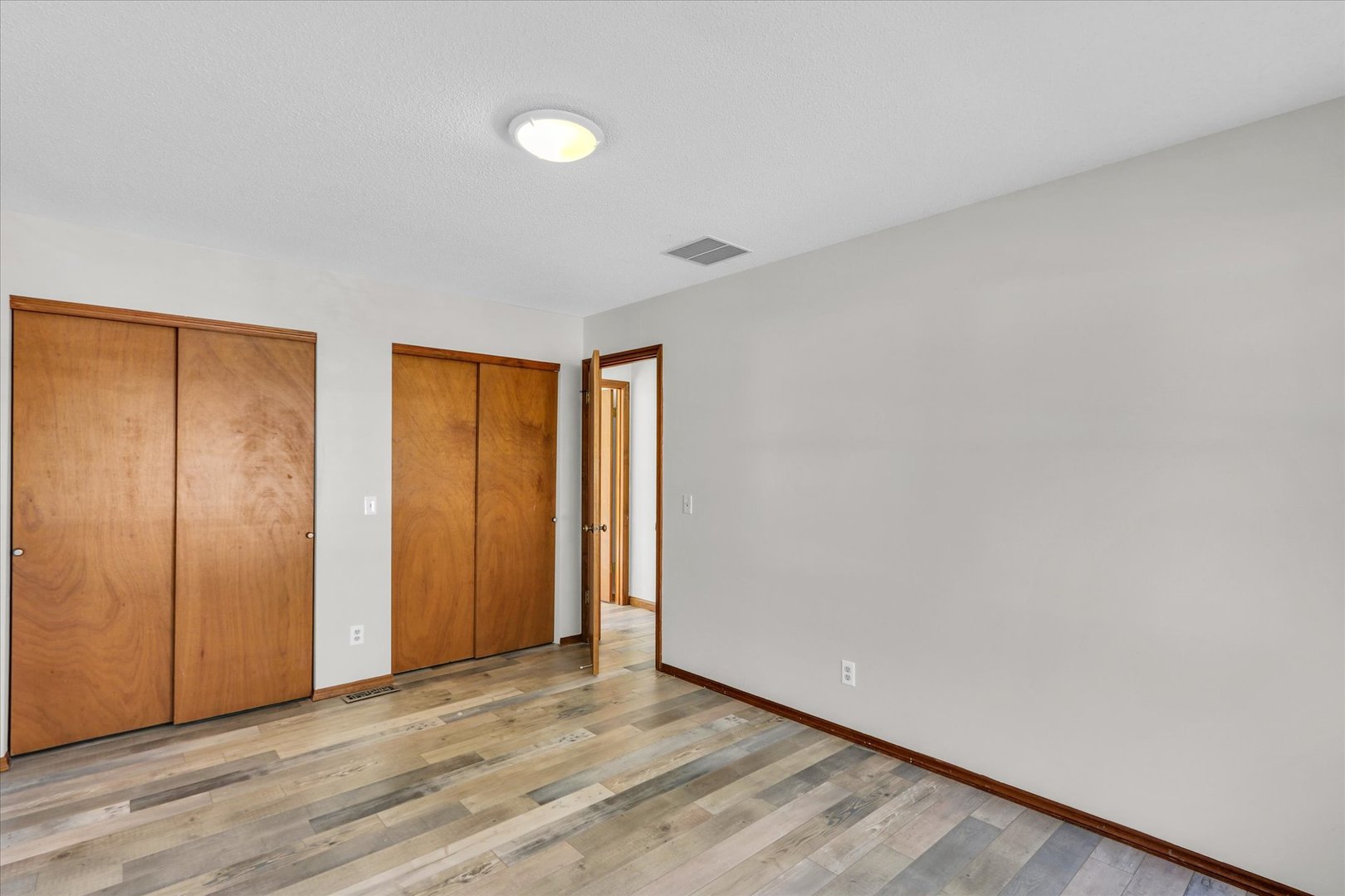 705 East Scovill Street Urbana, IL 61801 - Photo 17 of 28 a view of an empty room with wooden floor and closet