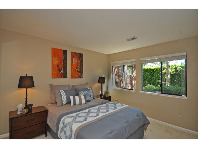 1691 Grant Road Mountain View, CA 94040 - Photo 11 of 25 a bedroom with a bed and a lamp