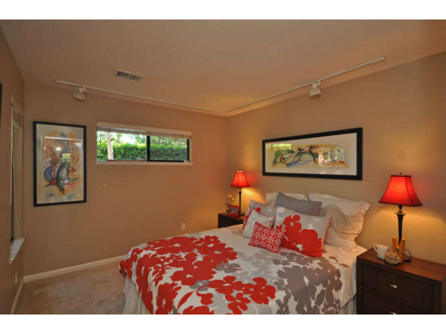 1691 Grant Road Mountain View, CA 94040 - Photo 14 of 25 a bedroom with a bed and a lamp on dresser