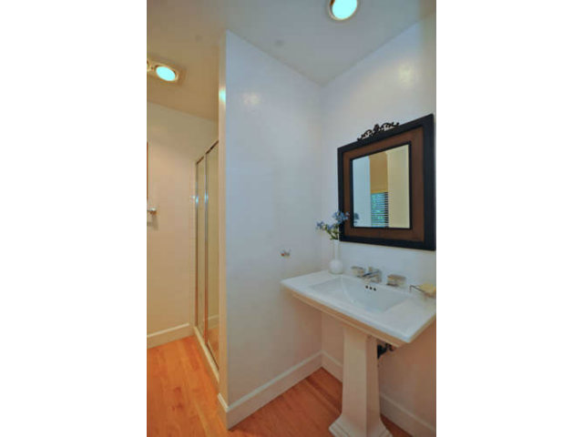 1691 Grant Road Mountain View, CA 94040 - Photo 22 of 25 a bathroom with a sink a mirror and a toilet