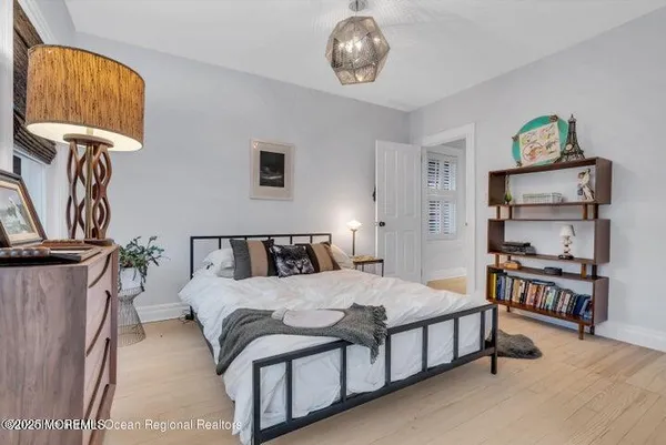 a bedroom with a bed and a chandelier
