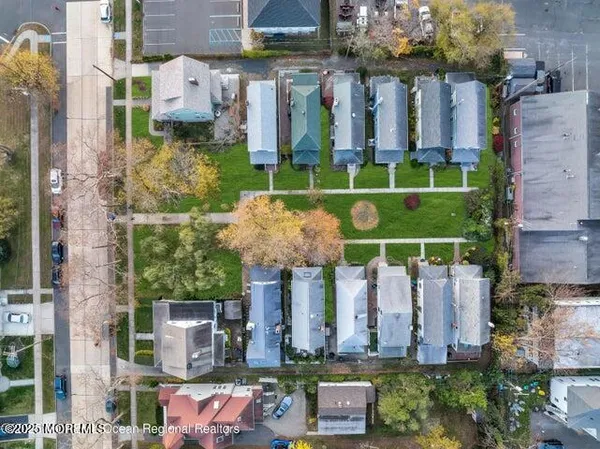 an aerial view of a house with a garden and trees