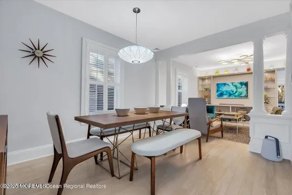 a living room with furniture a window and a chandelier