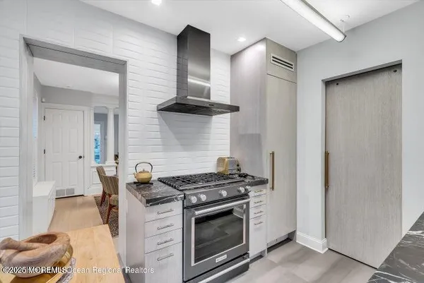 a kitchen with a stove and a wooden cabinets