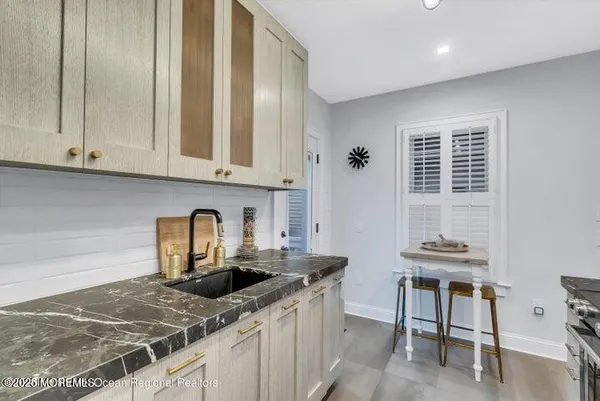 a kitchen with stainless steel appliances granite countertop a sink and cabinets
