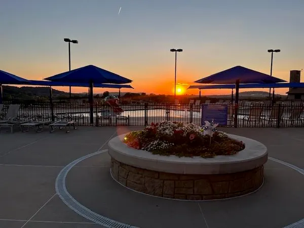 a view of a patio with table and chairs under an umbrella