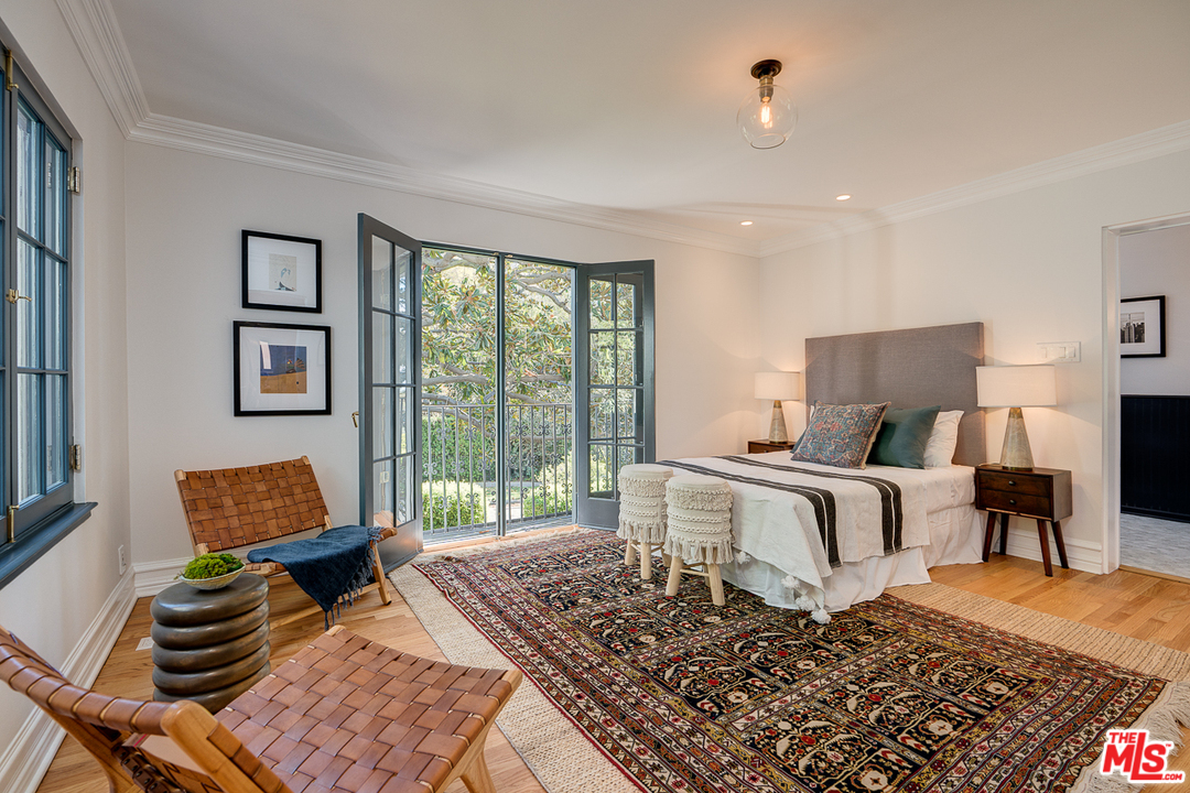 2529 North Commonwealth Avenue Los Angeles, CA 90027 - Photo 30 of 45 a bedroom with a bed and glass window