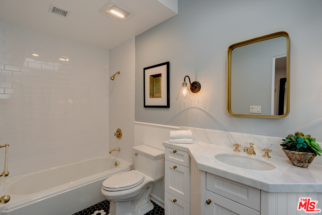 2529 North Commonwealth Avenue Los Angeles, CA 90027 - Photo 34 of 45 a bathroom with a sink a toilet and a mirror