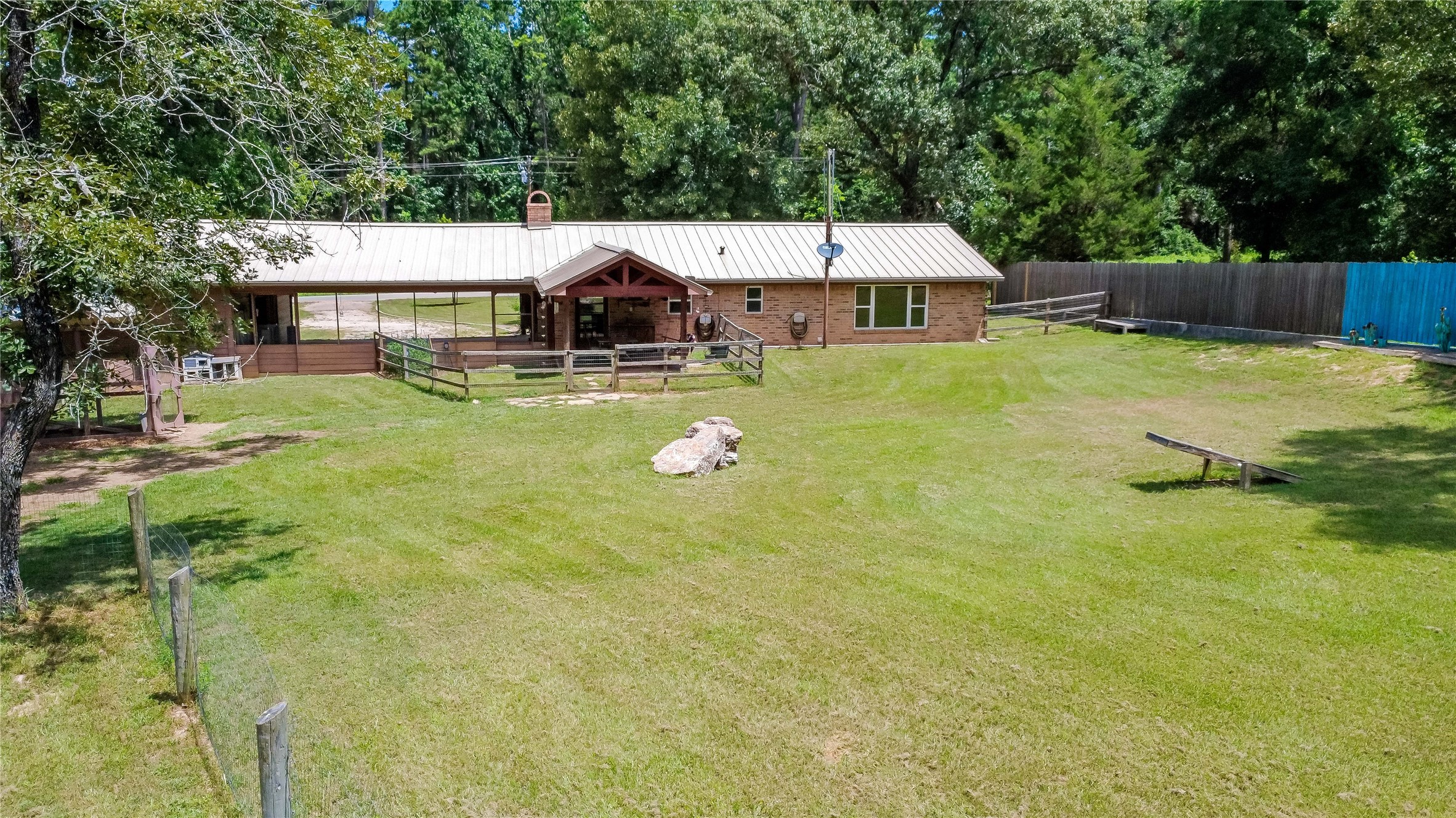 891 Lower Vann Road Coldspring, TX 77331 - Photo 12 of 23 a house view with a sitting space and garden space