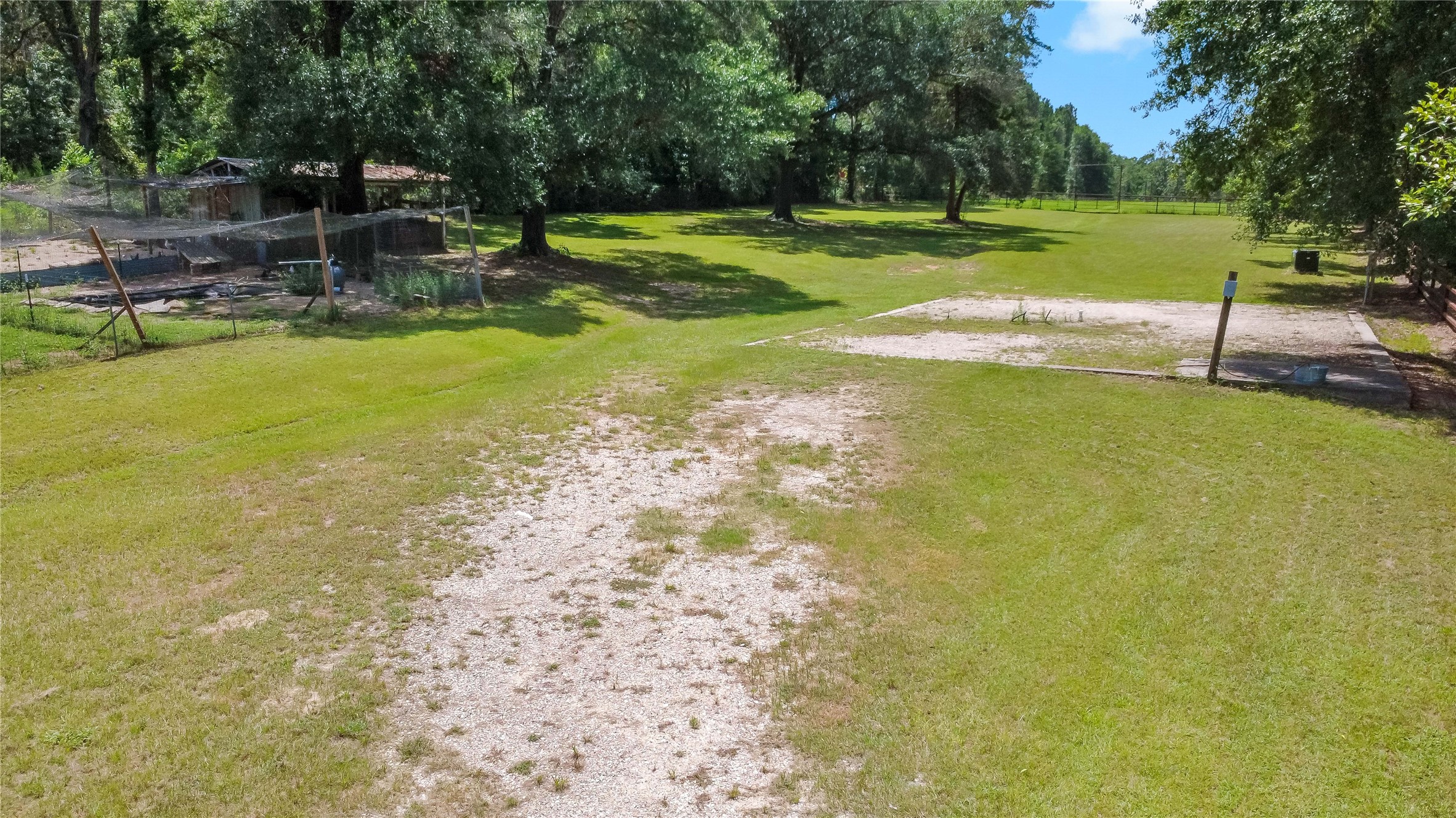 891 Lower Vann Road Coldspring, TX 77331 - Photo 14 of 23 a view of a swimming pool with a bench and trees