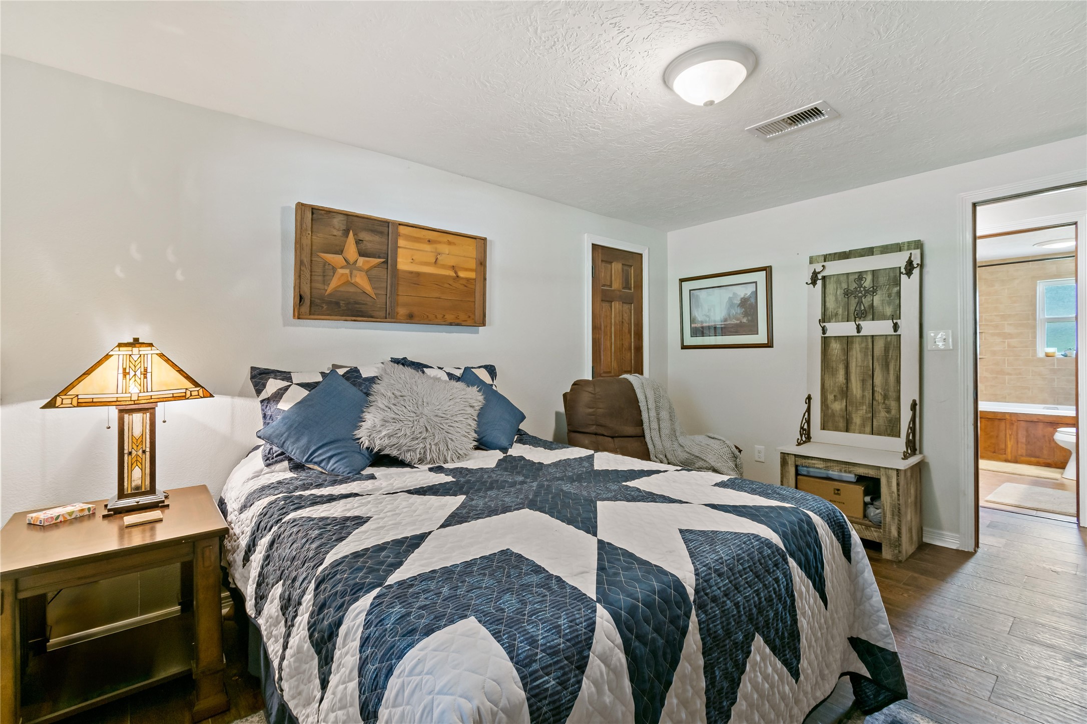 891 Lower Vann Road Coldspring, TX 77331 - Photo 19 of 23 a bed room with a bed and a lamp