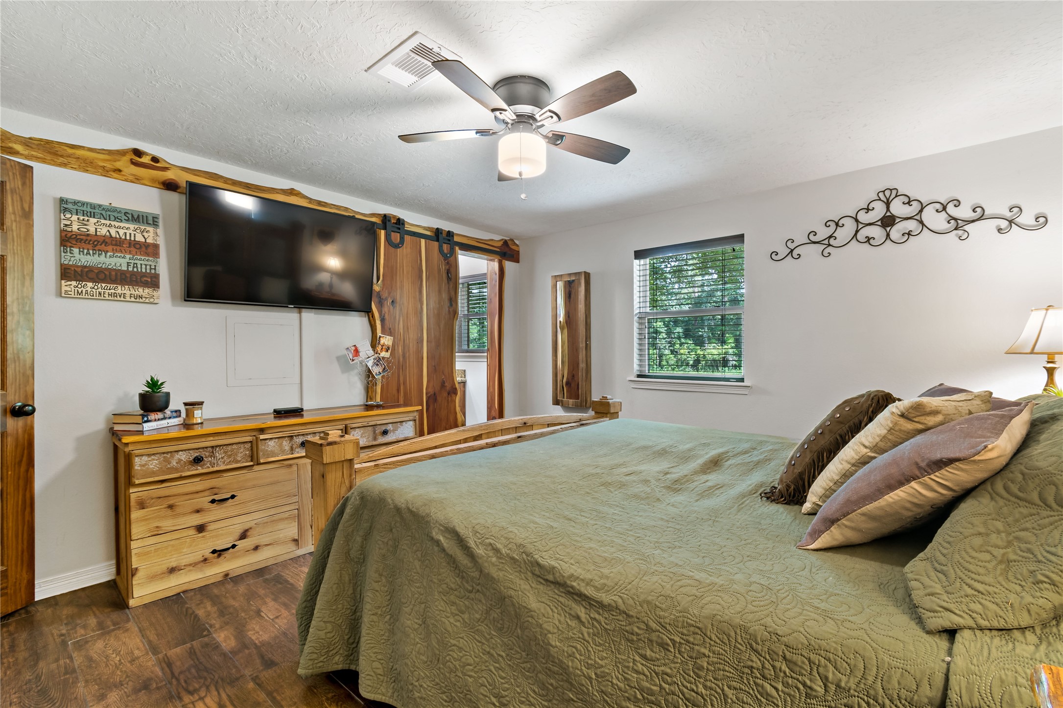 891 Lower Vann Road Coldspring, TX 77331 - Photo 21 of 23 a bedroom with a bed and a flat screen tv