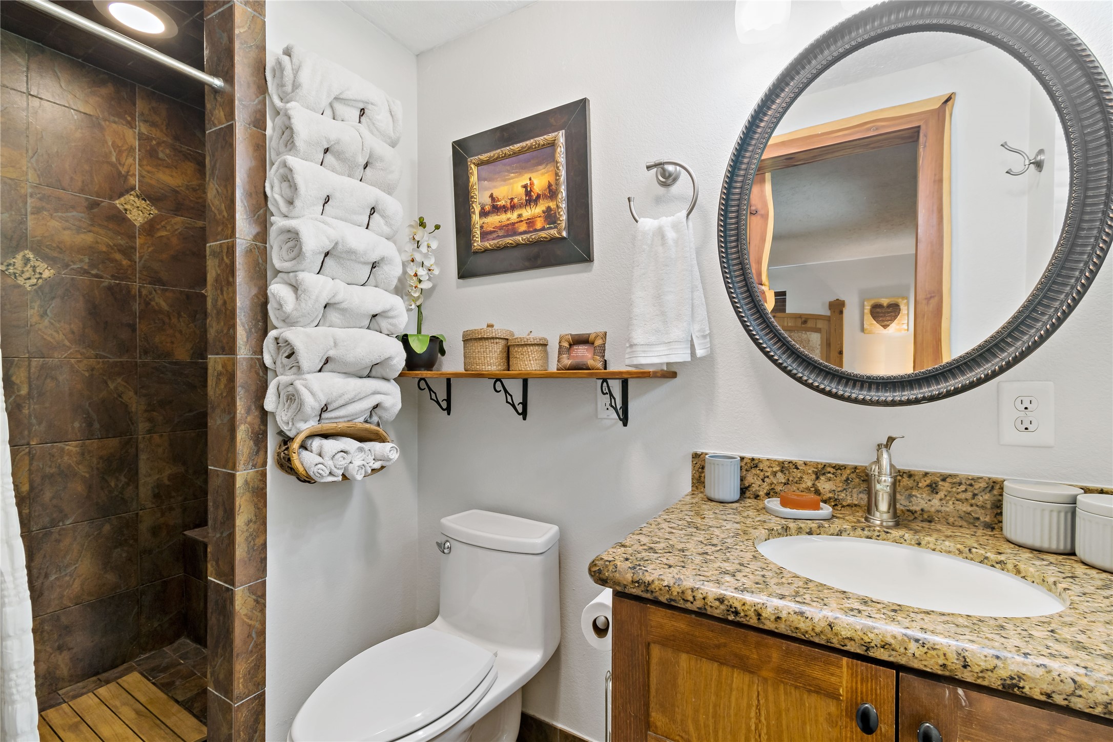 891 Lower Vann Road Coldspring, TX 77331 - Photo 22 of 23 a bathroom with a granite countertop toilet a sink and a mirror