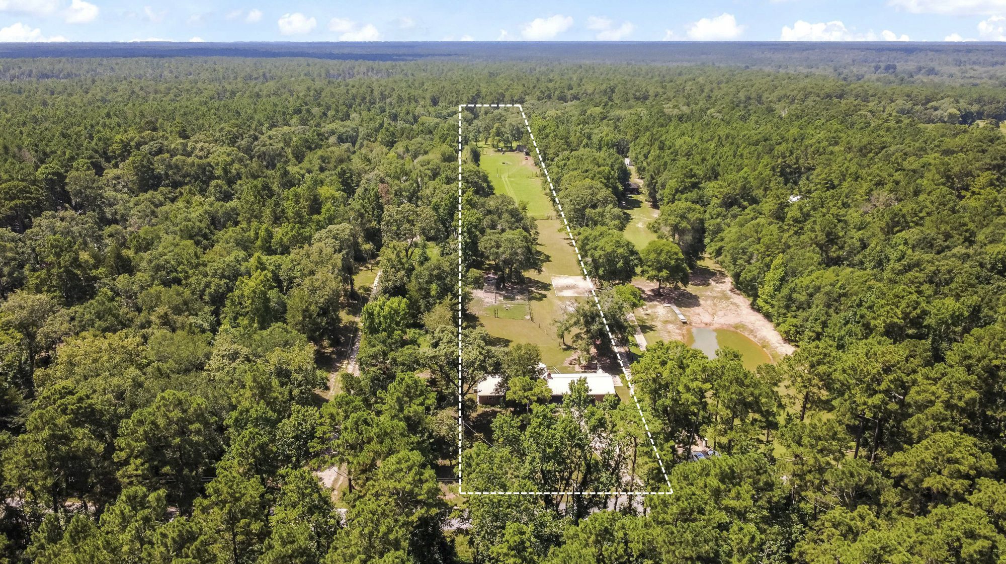 891 Lower Vann Road Coldspring, TX 77331 - Photo 9 of 23 a view of a green field with lots of bushes
