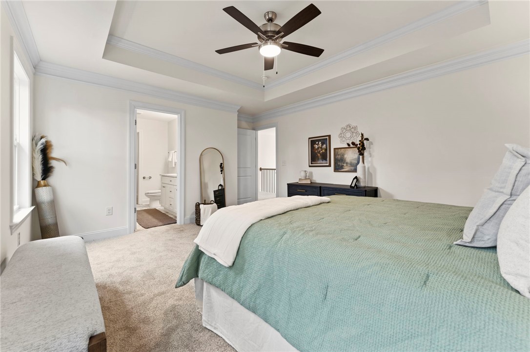 505 Fire Tower Road Williamston, SC 29697 - Photo 21 of 37 This inviting bedroom features a cozy retreat with an adjacent bathroom and plush carpeting.