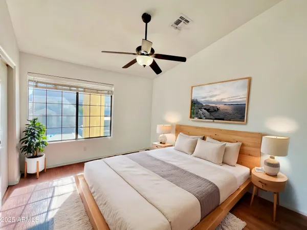 a bedroom with a bed and wooden floor