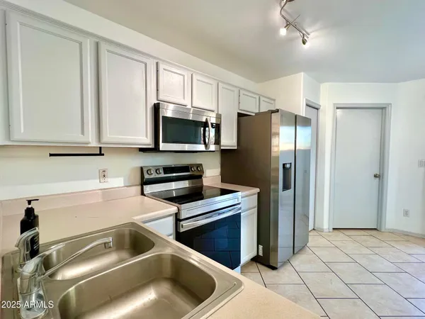 a kitchen with a refrigerator sink and microwave