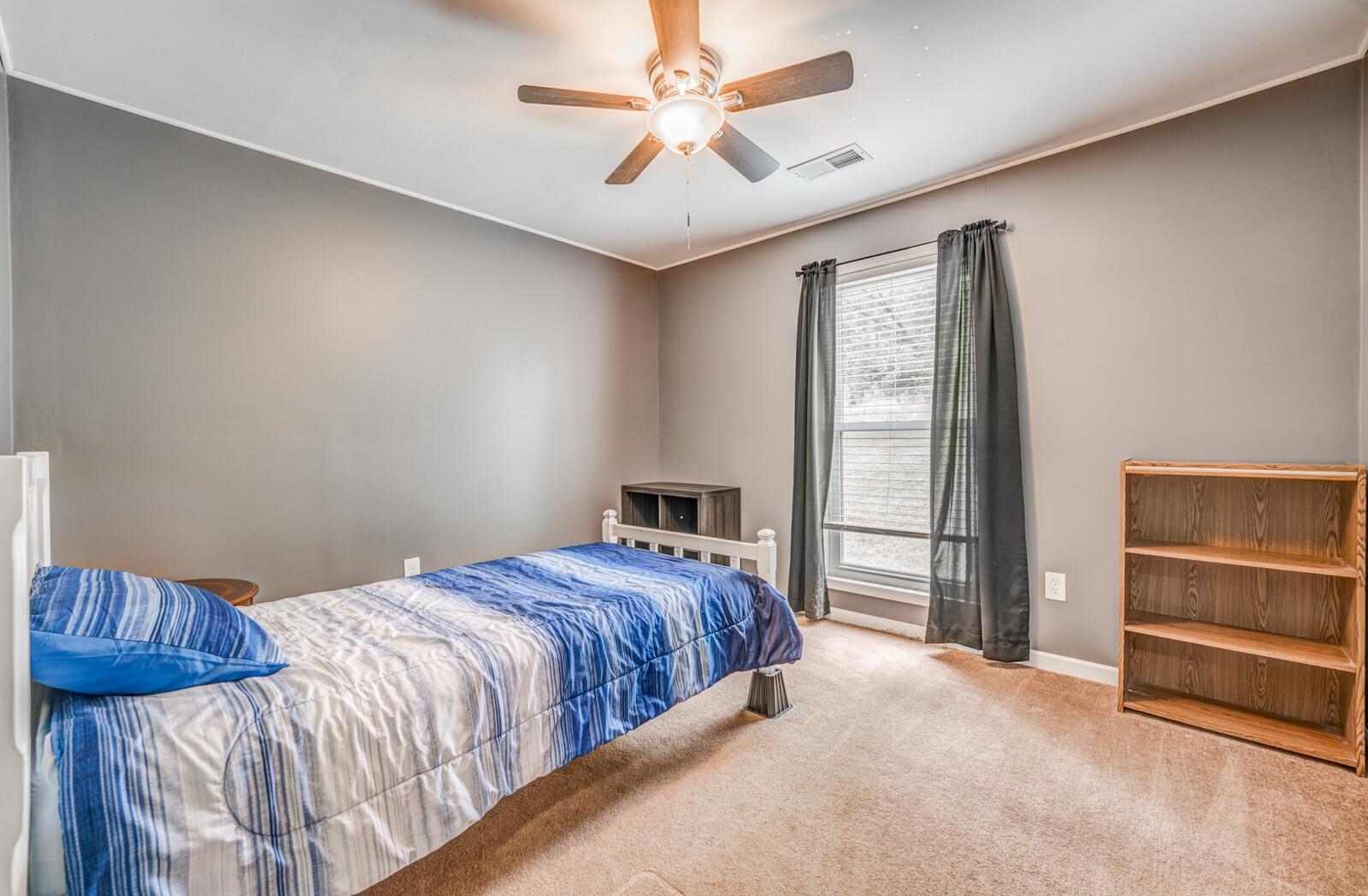 6125 Warren Road Oakland, TN 38060 - Photo 27 of 40 Carpeted room featuring a ceiling fan with integrated lighting, a window with blinds, and neutral-toned walls