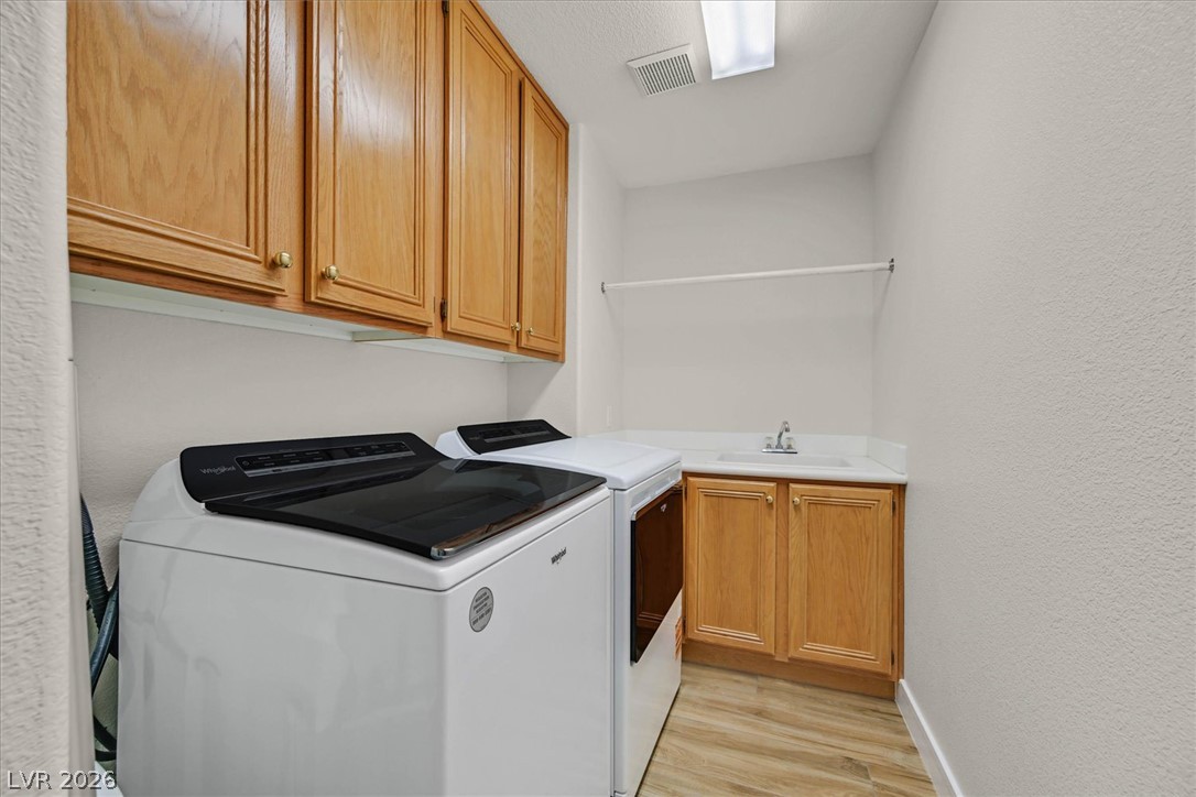 1259 Moon Vision Street Henderson, NV 89052 - Photo 21 of 53 A well-appointed laundry area, offering functionality and organized storage space.