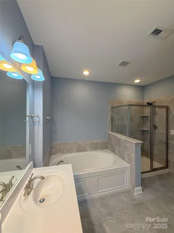 a bathroom with a tub and a sink